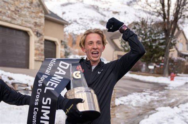 Daniel Simmons is pictured with two trophies.
