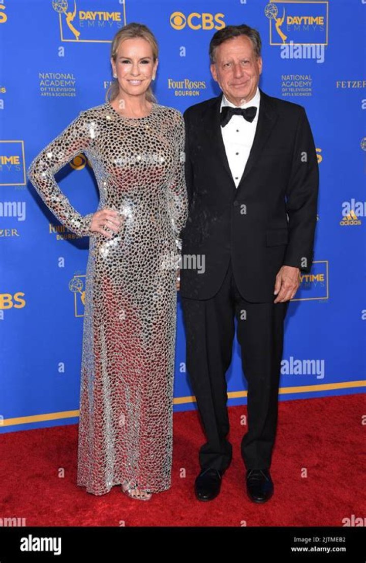 Dr. Jennifer Ashton and Tom Werner smiling on a red carpet