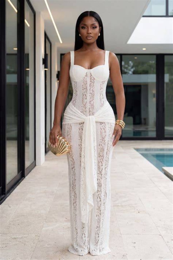 model wears an ivory lace top and matching long skirt