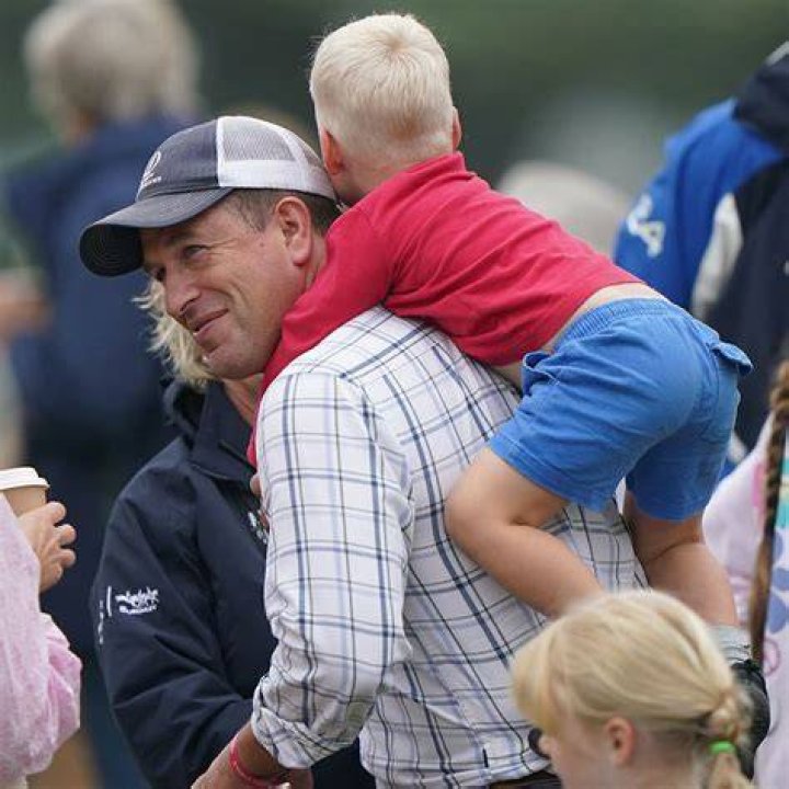 Peter Phillips and daughter Savannah, 11, share a moving moment at Queen's vigil